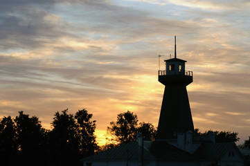 Dusky landscape with lighthouse and trees