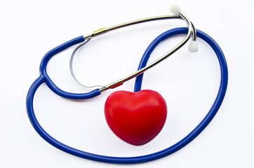 Red heart and blue stethoscope on white background