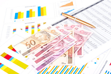 financial chart and datasheet. Brazilian money and pen.