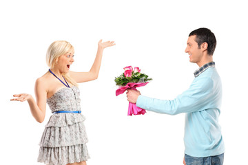 Boyfriend giving flowers to his surprised girlfriend