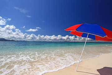 美しい砂浜の上に立つビーチパラソル