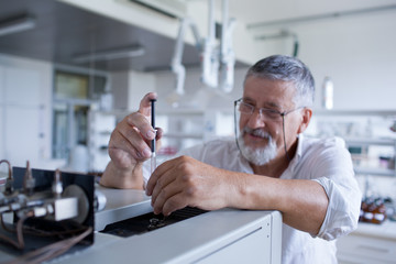 senior male researcher carrying out scientific research in a lab