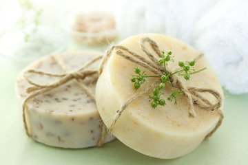 Bars of soap with bath salt and towel