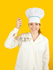 woman in chef uniform tasting from ladle