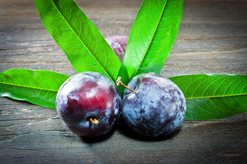 plum and leaf on wood