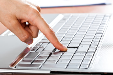 Finger pressing the enter button