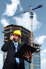 Construction engineer examine a project plan on site