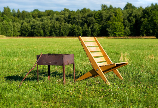 Armchair and barbecue outdoors