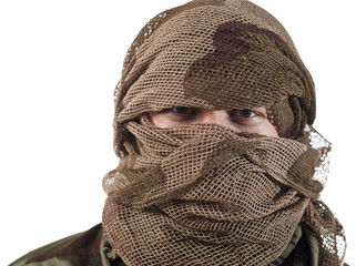 A hidden face of a guerrilla warrior with serious stare on eyes.