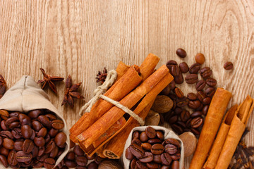 cinnamon, coffee, nutmeg and on wooden background