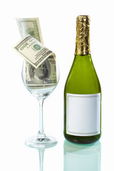 Glass filled of dollar bills and wine bottle