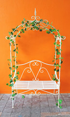 white romantic vintage chair with orange wall
