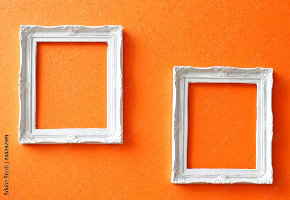 Wall mural two white vintage frames on orange wall