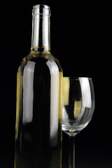 Bottle of white wine and a crystal wineglass