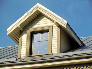 Iron roof, white dormer and blue sky