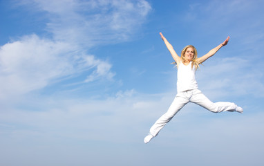 Fototapeta premium Beautiful blond girl flying in the air, concept of freedom