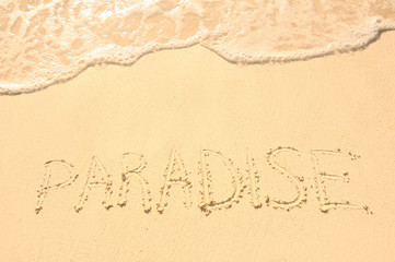 Paradise Written in Sand on Beach
