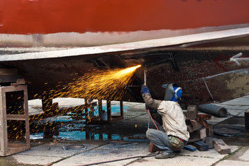 Worker cutting iron ship plate