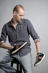 young man studying shoes