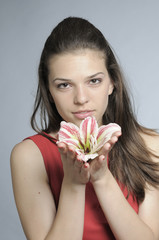 beautiful woman showing beauty of lily flower