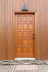 wooden door on a  wooden paneling wall