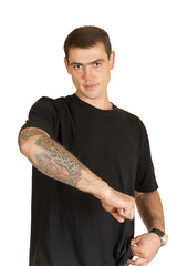 handsome young man shows a tattoo on his arm