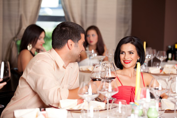 young couple toasting restaurant table