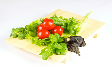 fresh and juicy vegetables on the wood plate isolated