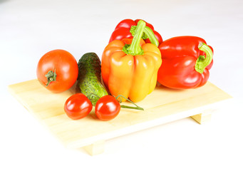 fresh and juicy vegetables on the wood plate isolated