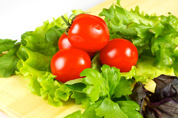 fresh and juicy vegetables on the wood plate isolated