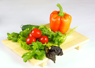fresh and juicy vegetables on the wood plate isolated