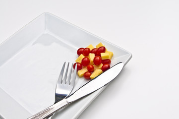 Chese and tomatoes on a white plate