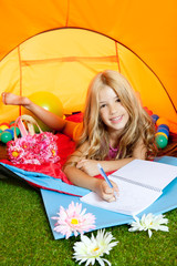 Children girl writing notebook in camping tent with flowers
