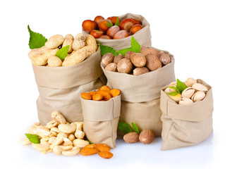 variety of nuts in bags on white isolated