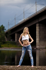 young sexy woman in jeans at the river