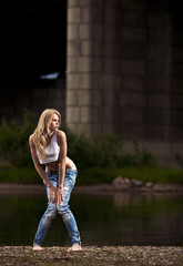 young sexy woman in jeans at the river