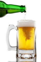 Beer is pouring into glass on white background