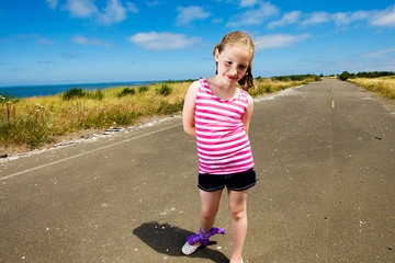 Cute young girl on a quiet, country road.