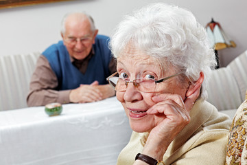 aged woman with glasses and hearing aid