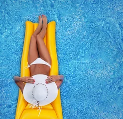 Fotobehang Woman relaxing in a pool © NinaMalyna