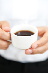 a woman drinkig a cup of coffee