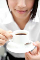 a woman drinking a cup of coffee