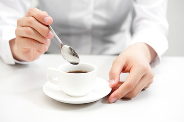 a woman drinking a cup of coffee