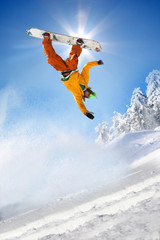 Snowboarder jumping against blue sky - 34344721