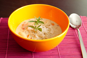 fresh lentil soup in an orange bowl