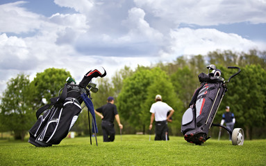 Golf bags with group of players