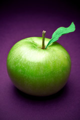 Green fresh apple on blue background