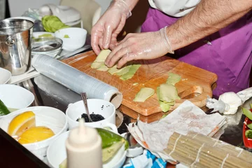 Foto op Canvas chef preparing sushi in the kitchen © Maksim Shebeko