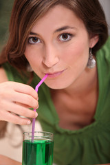 tight shot of a brunette drinking
