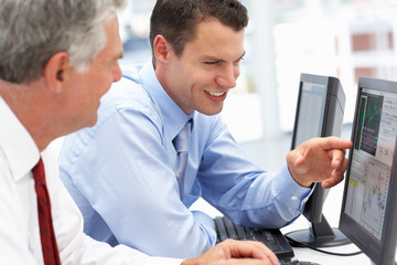 Businessmen working on computers